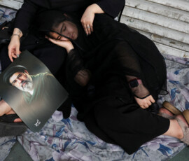 A mourner rests next to an image of Iran's Supreme Leader Mojtaba Khamenei on the day of a funeral procession for Iran's late Supreme Leader Ayatollah Ali Khamenei, who was killed on February 28 in Israeli and U.S. airstrikes, in Tehran, Iran, July 6, 2026. REUTERS/Murad Sezer