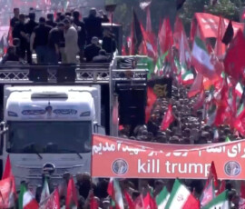 People carry an anti-Trump banner as they walk next to a vehicle during a funeral procession for Iran's late Supreme Leader Ayatollah Ali Khamenei, who was killed on February 28 in Israeli and U.S. airstrikes, in Tehran, Iran July 6, 2026, in this still image taken from video. IRIB via REUTERS TV/via REUTERS