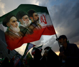 FILE PHOTO: A man holds a flag with a picture of late leader of the Islamic Revolution Ayatollah Ruhollah Khomeini, late Supreme Leader of Iran Ayatollah Ali Khamenei and Iran's new Supreme Leader Mojtaba Khamenei, during a rally in Tehran, Iran, April 29, 2026. Majid Asgaripour/WANA (West Asia News Agency) via REUTERS ATTENTION EDITORS - THIS PICTURE WAS PROVIDED BY A THIRD PARTY/File Photo